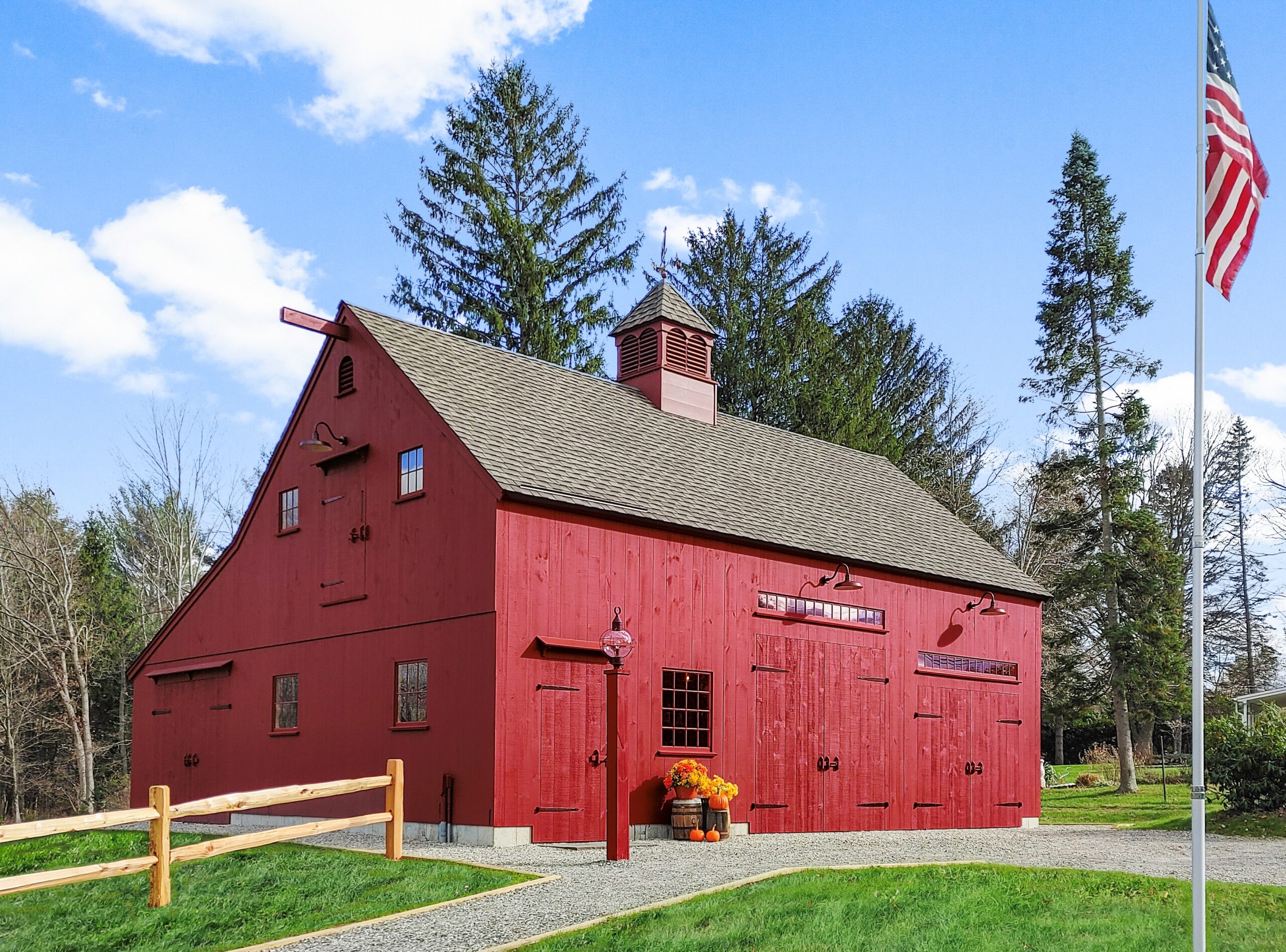 Red Barn with a blue sky and an American Flag