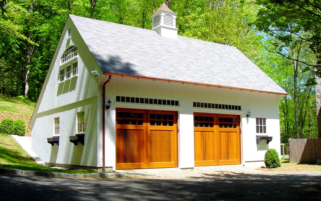 White Saltbox Garage with Stained wood Overhead doors and copper gutters