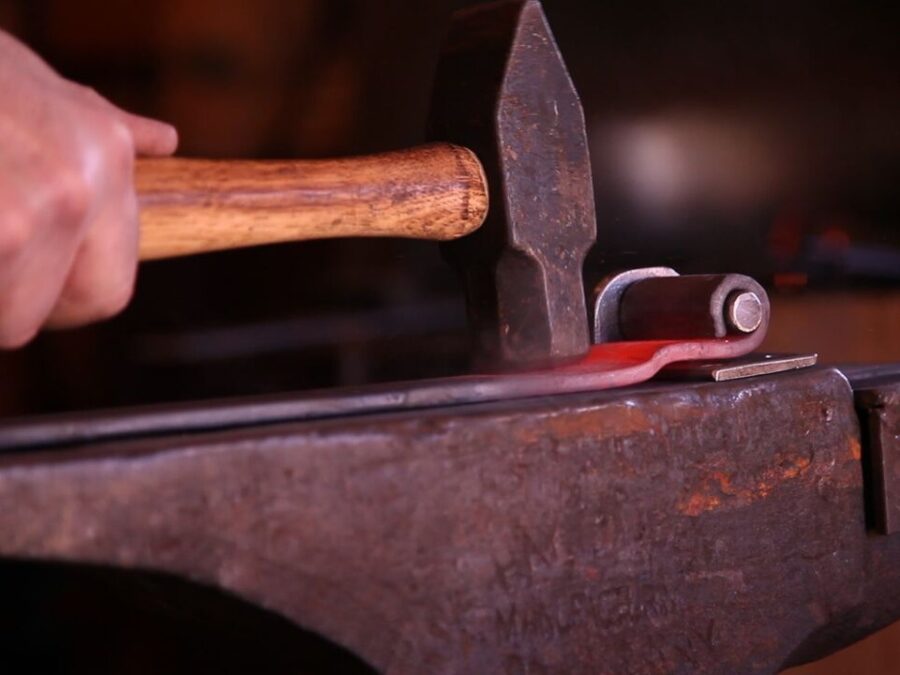 Blacksmith creating hinge