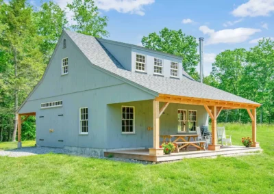 Gray one story barn with porch