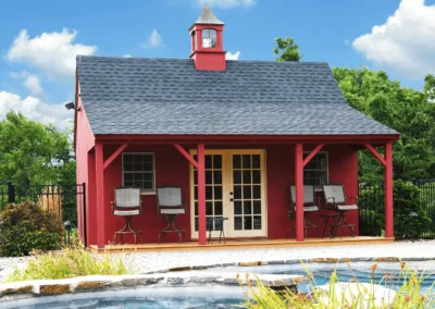 Red pool house with a porch