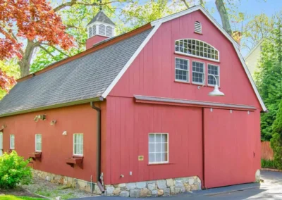 Red Gambrel style barn with sliding garage door